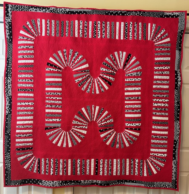 50 plus hours to complete the 57 X 57 inch quilt. Red, Black and White.